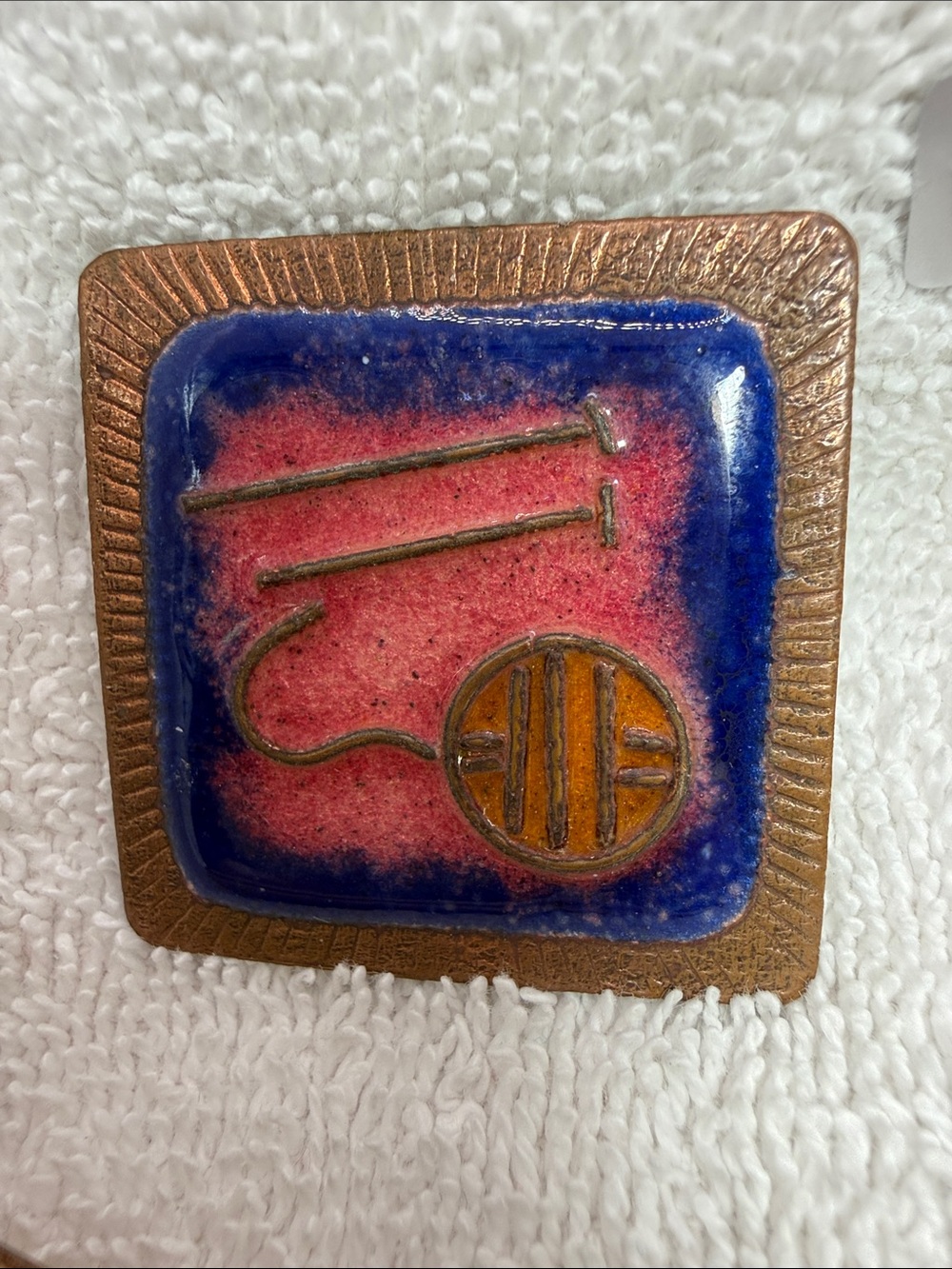 Enamel and Copper-Tone Square Brooch depicts a ball of yarn/needles